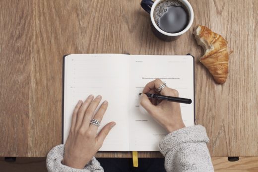 woman writing with coffee